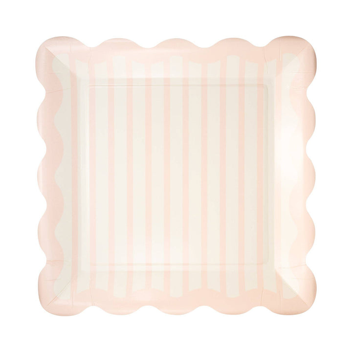 Pink scalloped plate on a white background