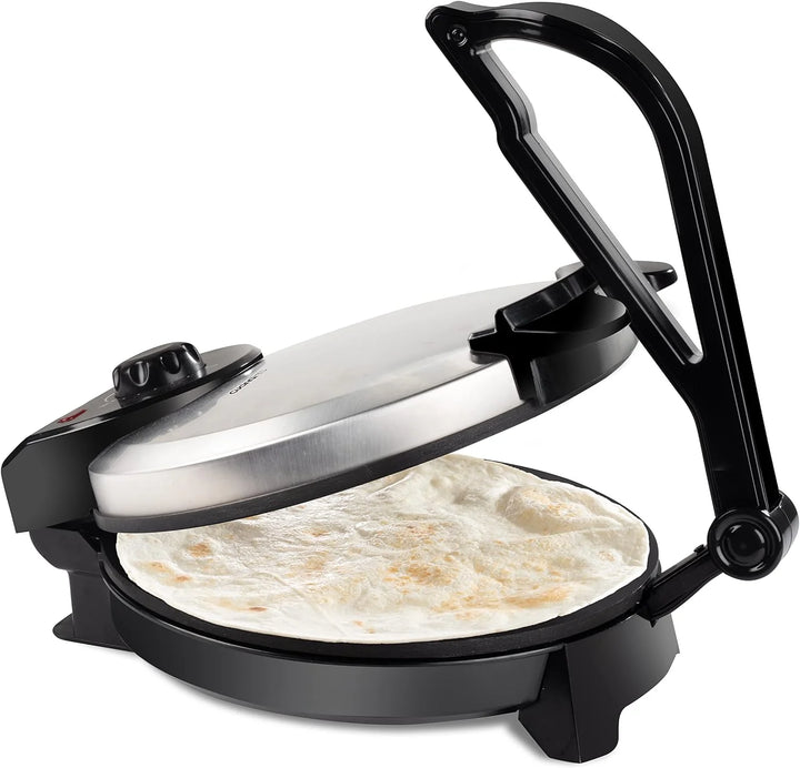 Black and silver tortilla press and griddle with tortillas inside on a white background