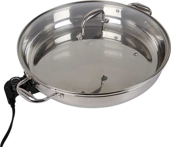Stainless steel electric skillet with a lid on a white background