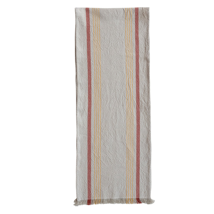 Striped table runner with red, yellow and beige stripes on a white background