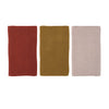 Textured kitchen towels in three colors on a white background
