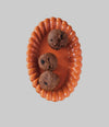 An orange decorative platter with pastries on it, on a white background.
