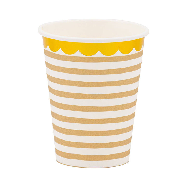 Paper cup with tan and white striped pattern and a gold foil scalloped rim on a white background