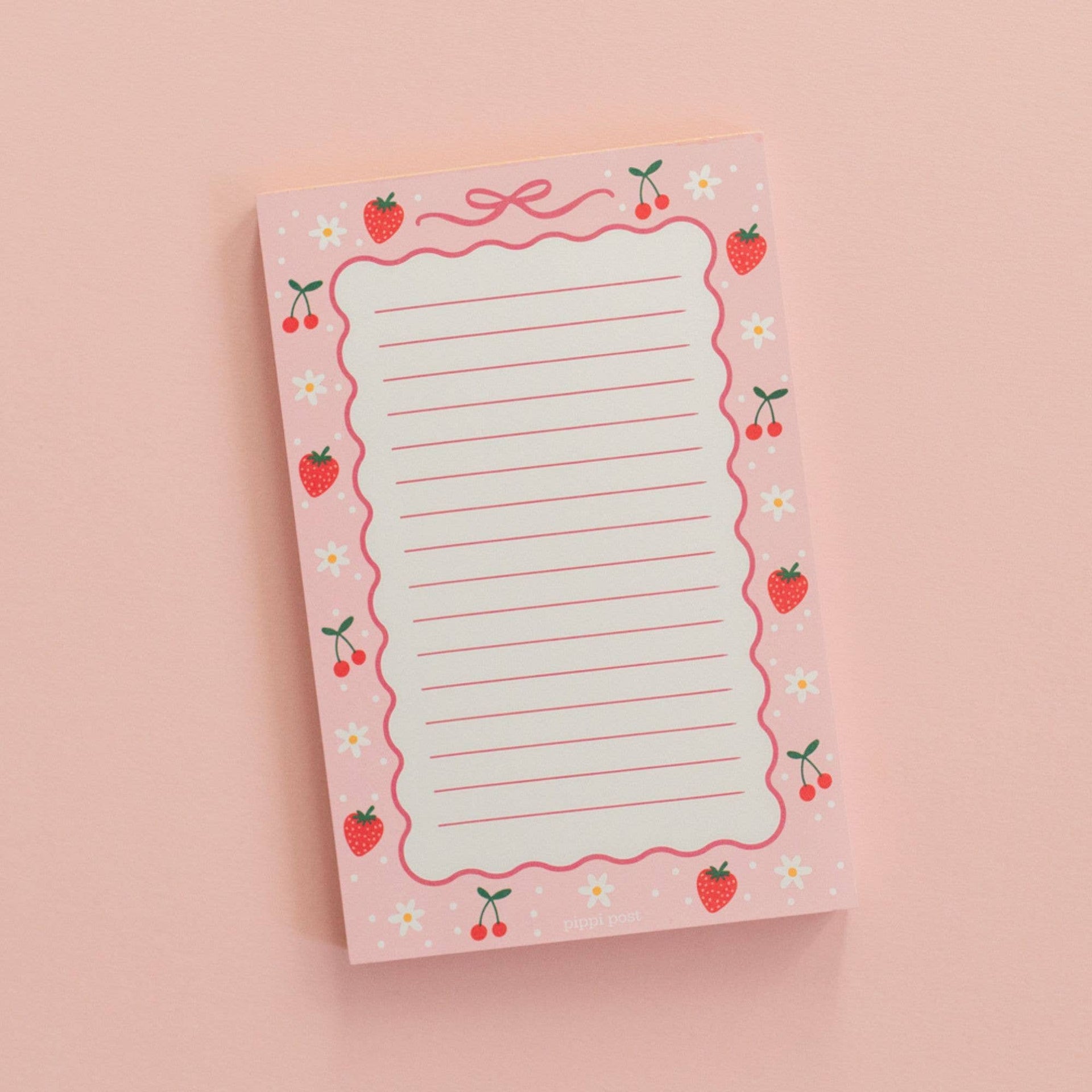 Notebook with strawberry and cherry design on a pink background