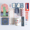 Collection of patriotic stationery items including a mug, notepads, and planners on a white background.