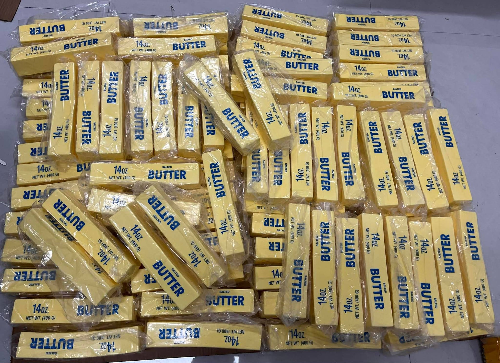 Multiple packages of butter squishy toys stacked on a flat surface