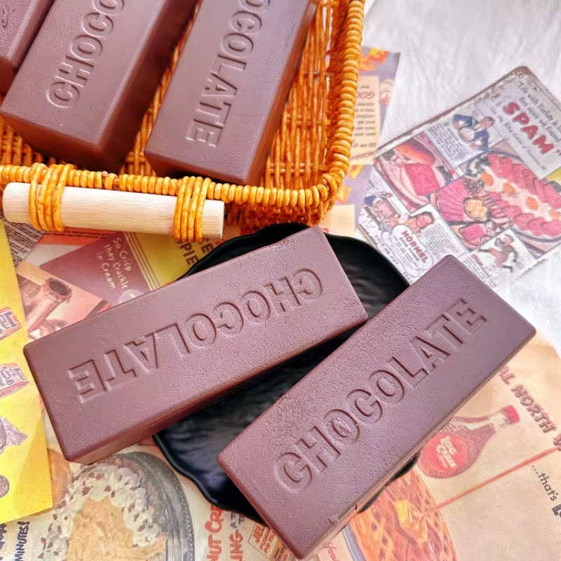 Chocolate squishy bars embossed with 'CHOCOLATE' on a newspaper background