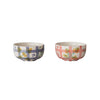 Two bowls with floral and plaid patterns on a white background