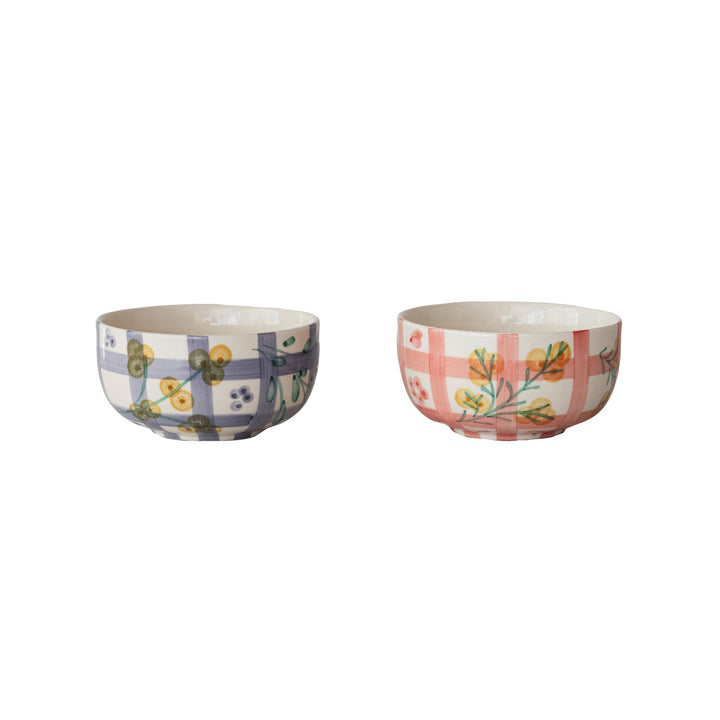 Two bowls with floral and plaid patterns on a white background