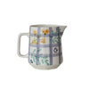 Stoneware pitcher with floral and plaid design on a white background