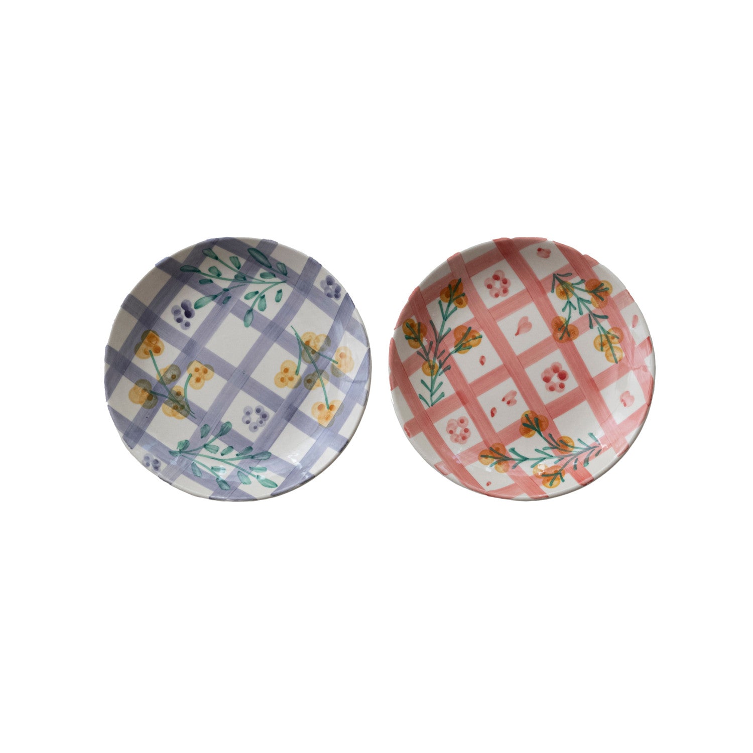 Two decorative plates with floral and checkered patterns on a white background
