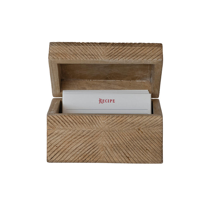 Wooden recipe box with a stack of recipe cards on a white background