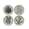 Four plates with leaf designs on a white background