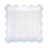 Decorative plate with scalloped edge and blue and white striped pattern on a white background