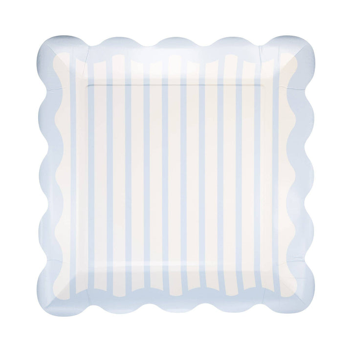 Decorative plate with scalloped edge and blue and white striped pattern on a white background