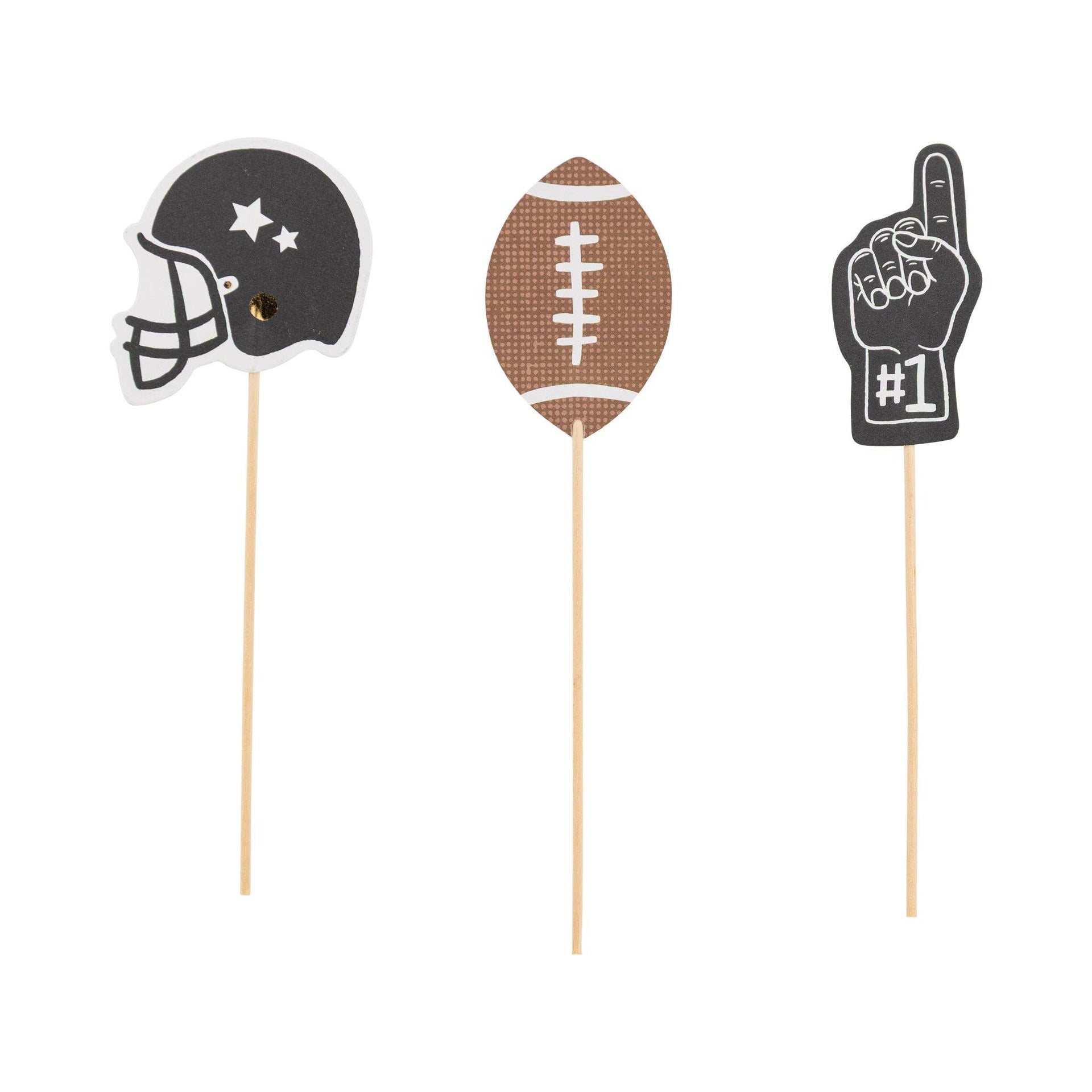 Three football themed toothpicks; a football helmet, football, and number one hand.