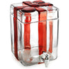 Clear glass drink dispenser with red ribbon and silver faucet on a white background