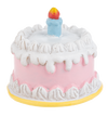 Birthday cake charm with white frosting and a colorful candle on a white background