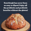 Sourdough bread on a wooden board with promotional text about probiotic and prebiotic benefits.