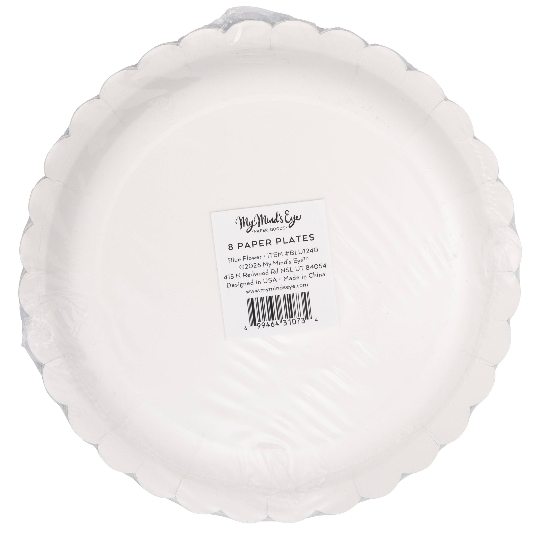 Bottom view of scalloped paper plate with a label on a white background