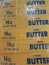 Stack of yellow butter squishy toy packages with blue text