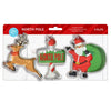 A 3-piece Christmas cookie cutter set in retail packaging, featuring a reindeer, a candy cane with a 'North Pole' sign, and Santa Claus with a green sack.