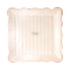 Pink scalloped plate with a brand logo on a white background