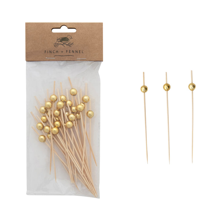 Packaged picks with a gold ball top on a white background 