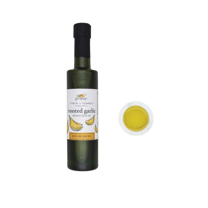 Bottle of roasted garlic olive oil with a close-up of the oil on a white background