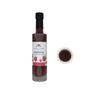 Bottle of raspberry barrel aged balsamic vinegar with a label on a white background