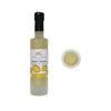 Bottle of meyer lemon white balsamic vinegar with a small sample on a white background
