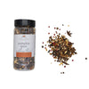 Jar of pumpkin spice mulling blend with scattered spices on a white background