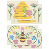 Two pop-up sponges featuring a beehive and bee design with flowers on a white background.