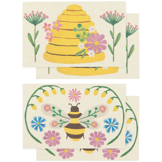 Two pop-up sponges featuring a beehive and bee design with flowers on a white background.