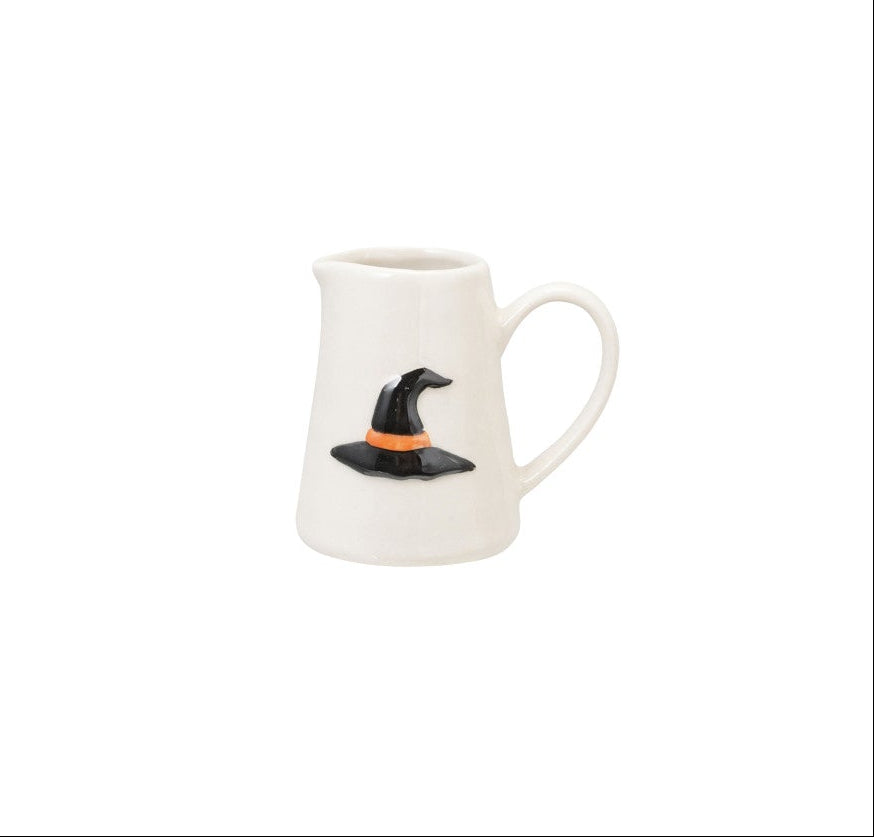 White halloween mug with witch hat design on a white background