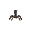 Decorative candle holder with spider-like design on a white background