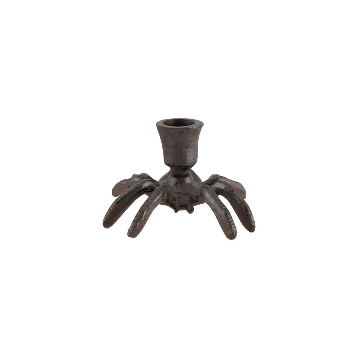 Decorative candle holder with spider-like design on a white background