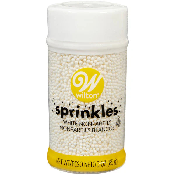 Bottle of Wilton white nonpareils sprinkles on a white background