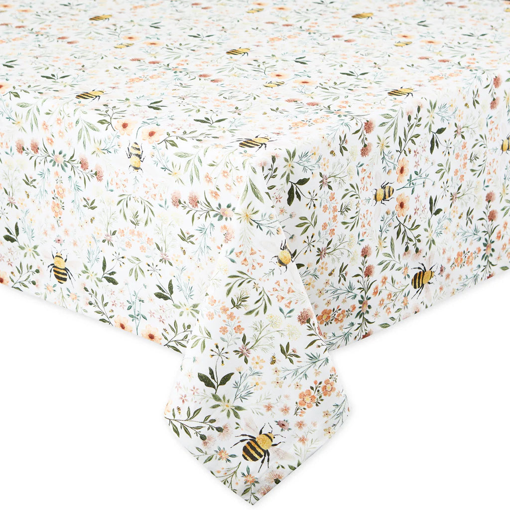Floral and bee patterned tablecloth on a white background