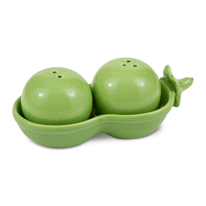 Green peas in a pod salt and pepper shaker set with a matching holder on a white background