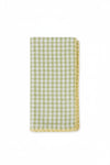 Green and white checkered napkin with a decorative edge on a white background