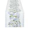 Table runner with blue floral pattern on a white background