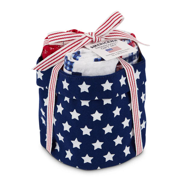 Fabric basket with star pattern containing rolled dish towels in various patriotic designs. Featured on a white background.
