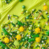 Close-up of a green frosted cake with colorful sprinkles
