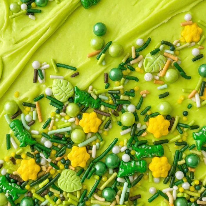 Close-up of a green frosted cake with colorful sprinkles