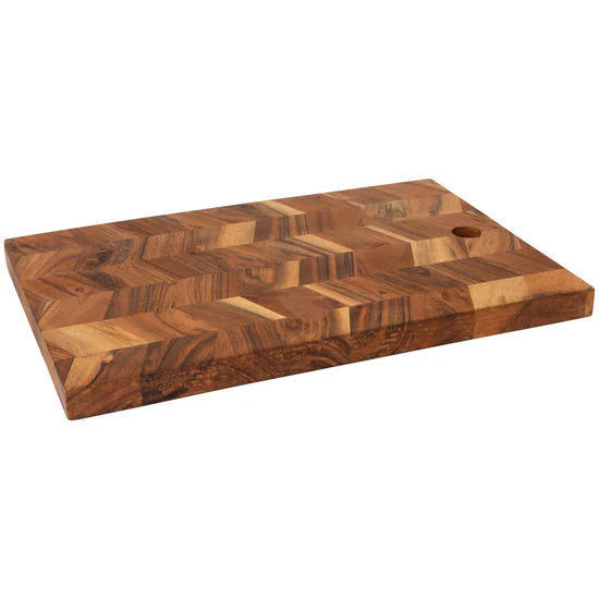 Wooden serving board with a chevron pattern on a white background