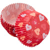 Red cupcake liners with heart patterns on a white background