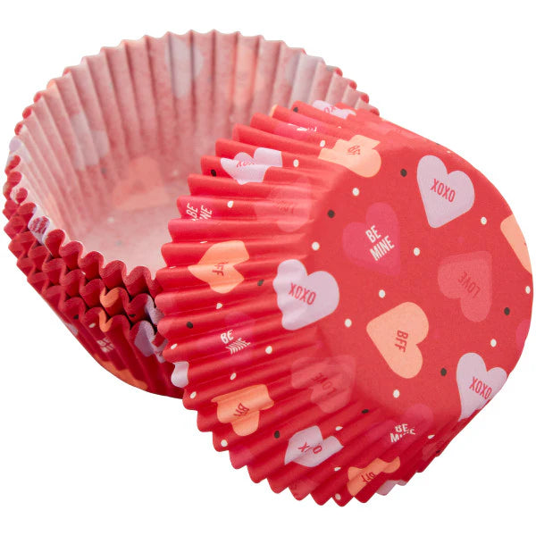 Red cupcake liners with heart patterns on a white background