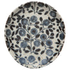 Stoneware plate with blue floral pattern on a white background