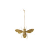 Gold bee-shaped ornament hanging on a white background